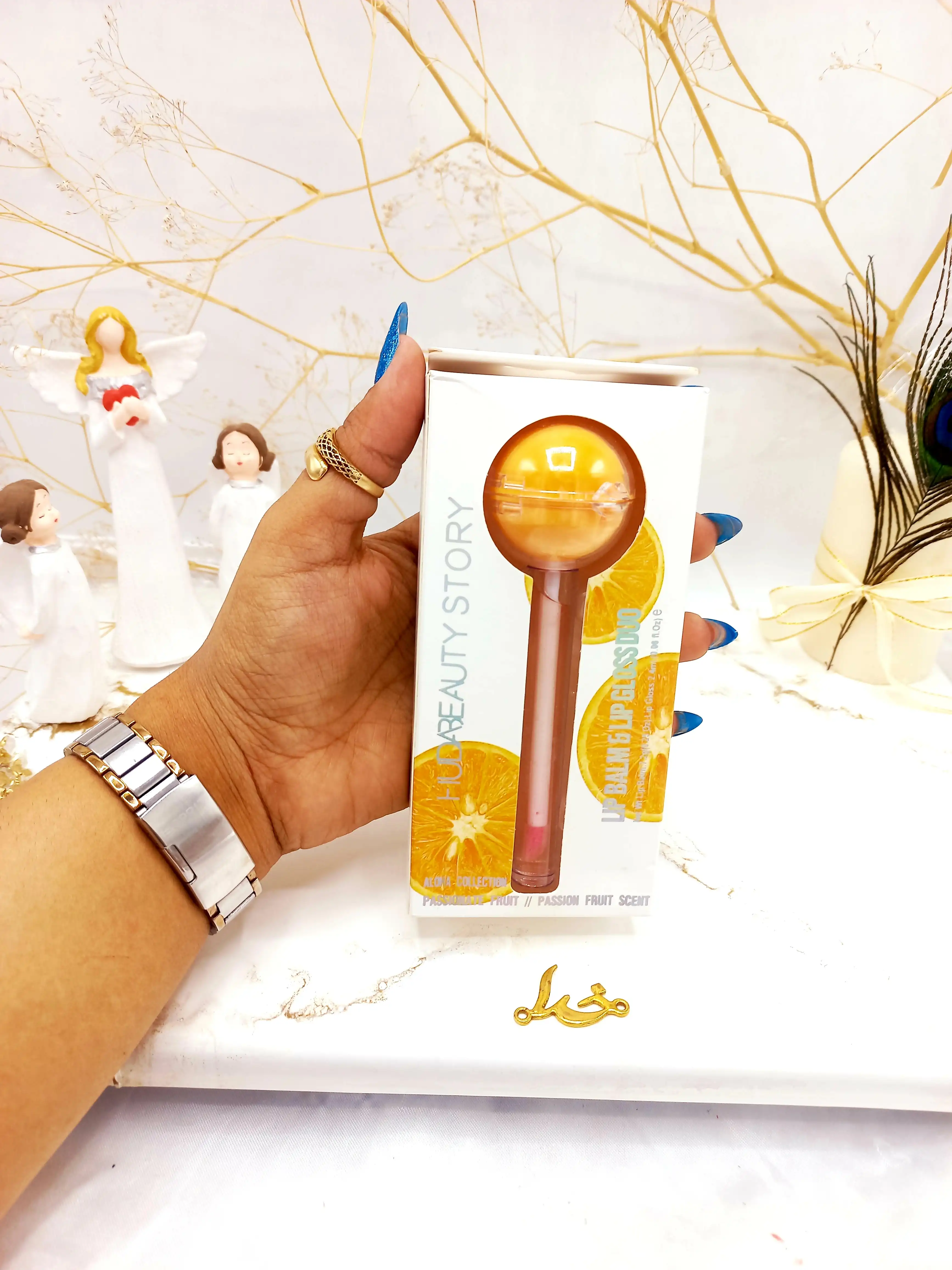 برق لب و بالم لب آبنباتی پرتقال هدا بیوتی استوری HUDA BEAUTY STORY